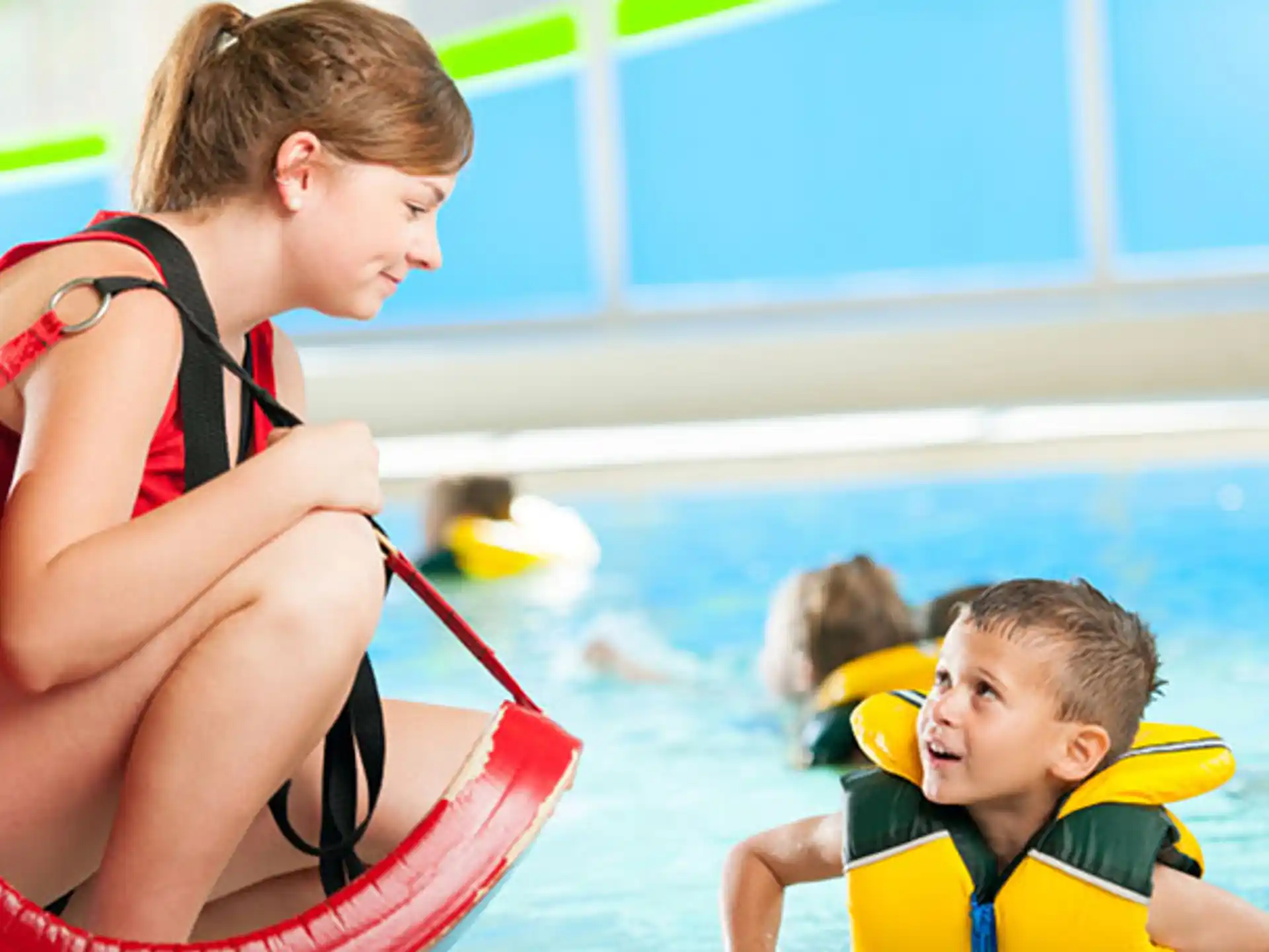 a person and a boy in a pool