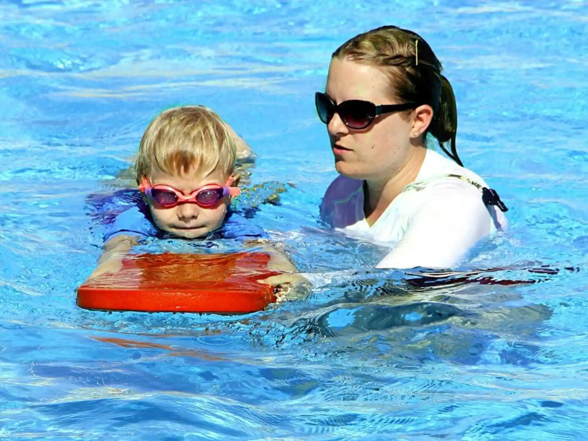 a person and a child in a pool