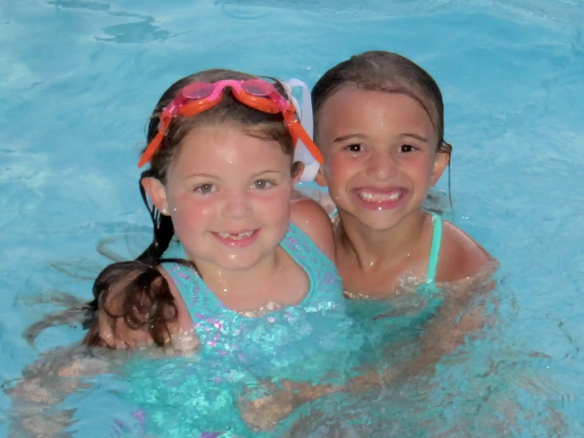 a couple of girls in a pool