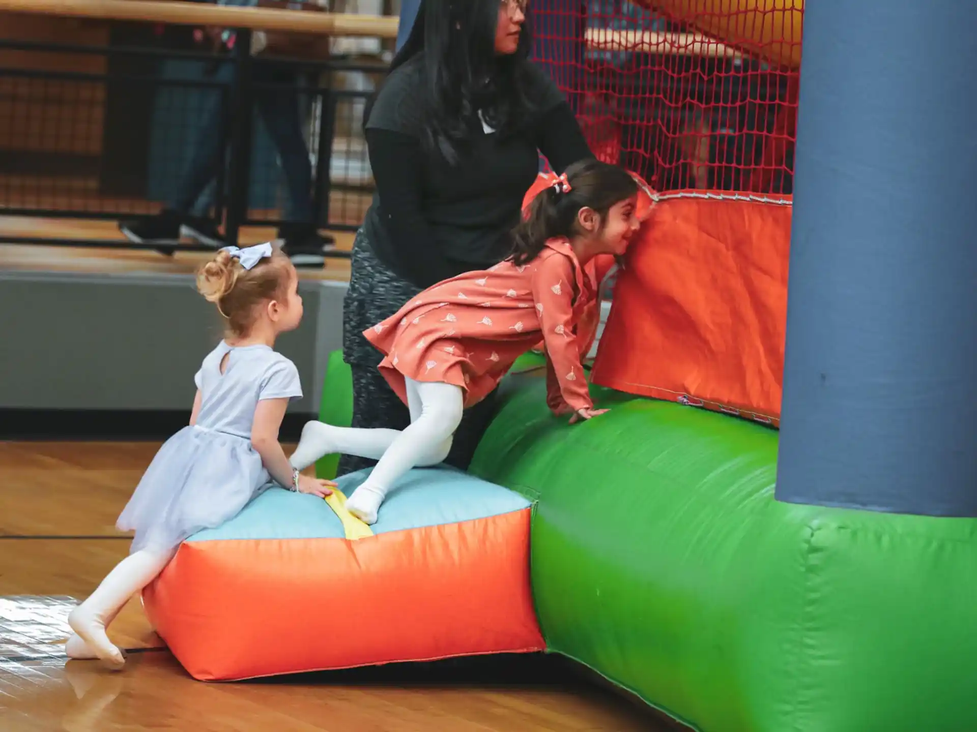 a person and a child playing on a large ball