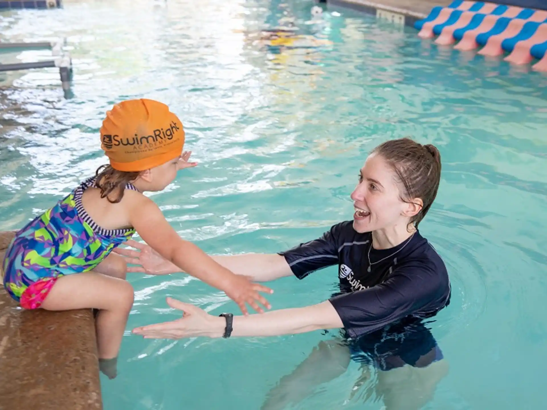 a person and a girl in a pool