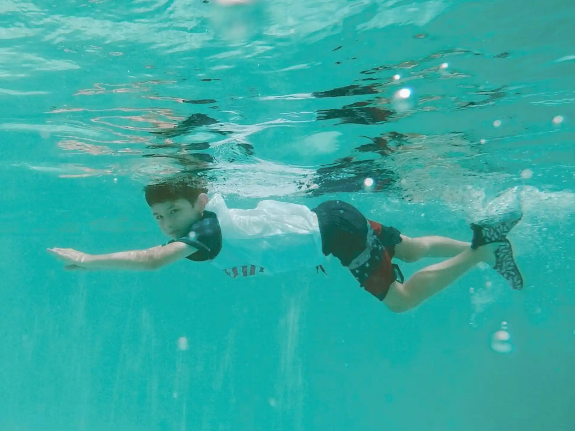 a man and woman swimming in water