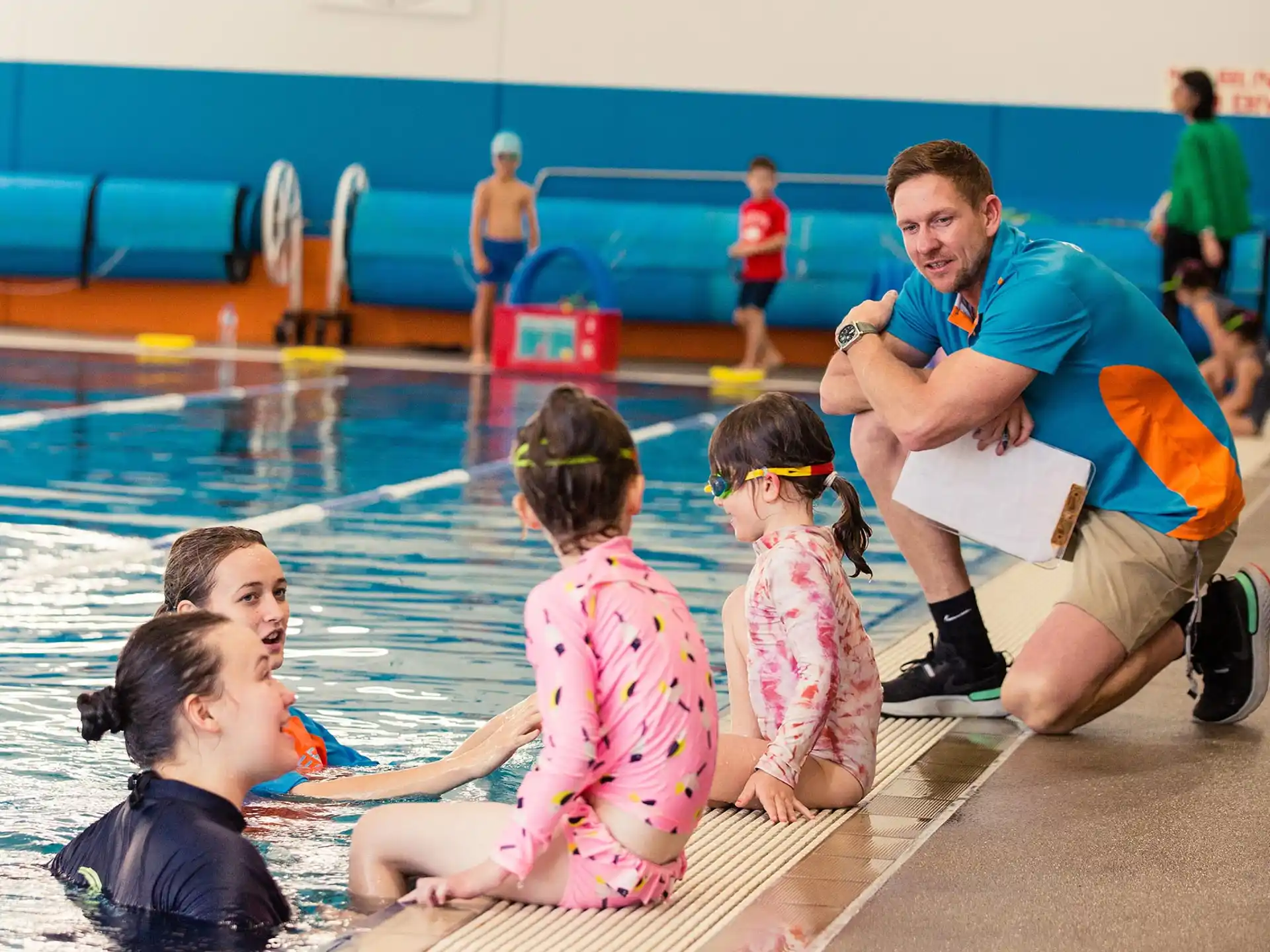 a man and a couple of children in a swimming pool