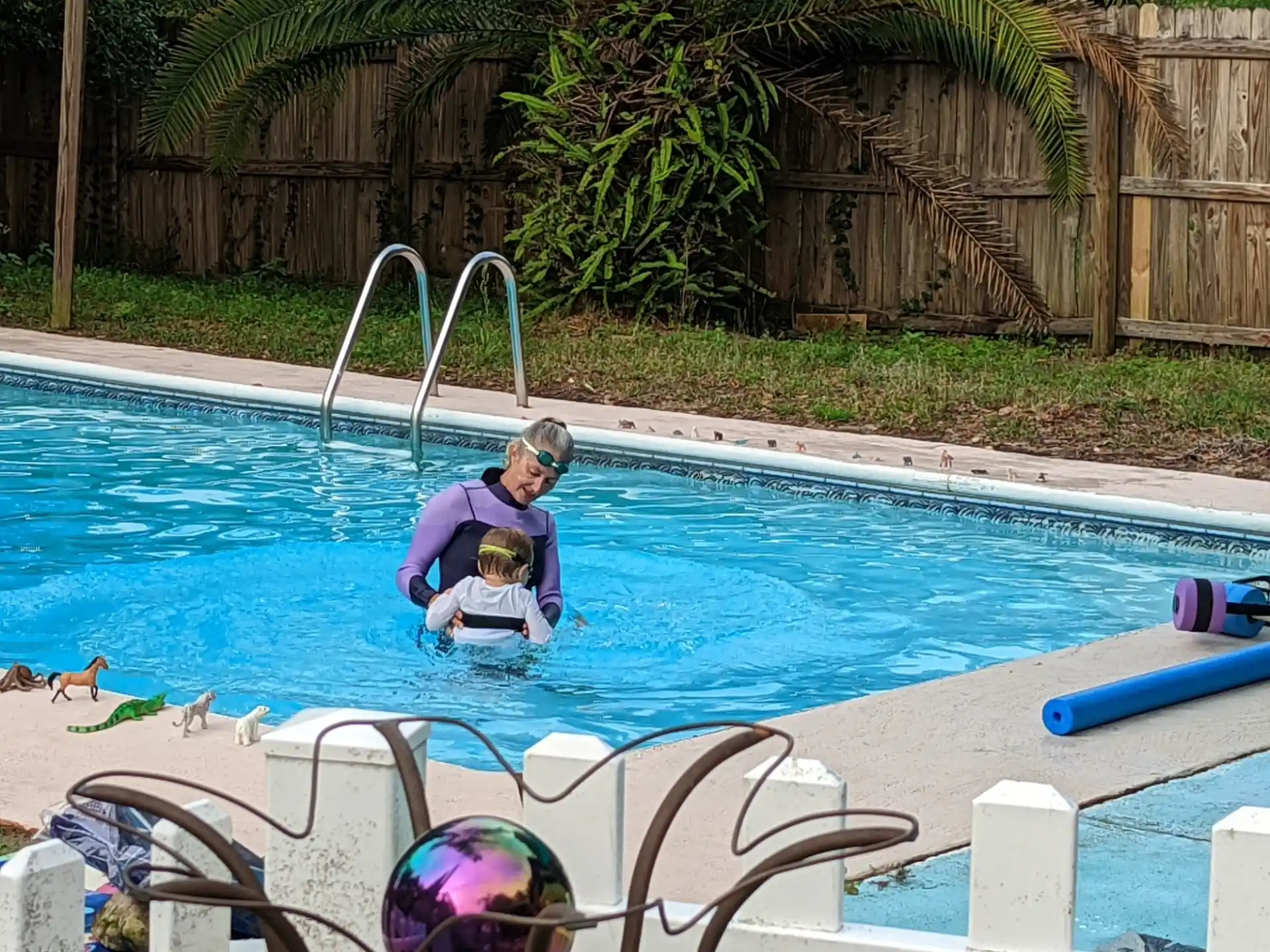 a person and a child in a swimming pool