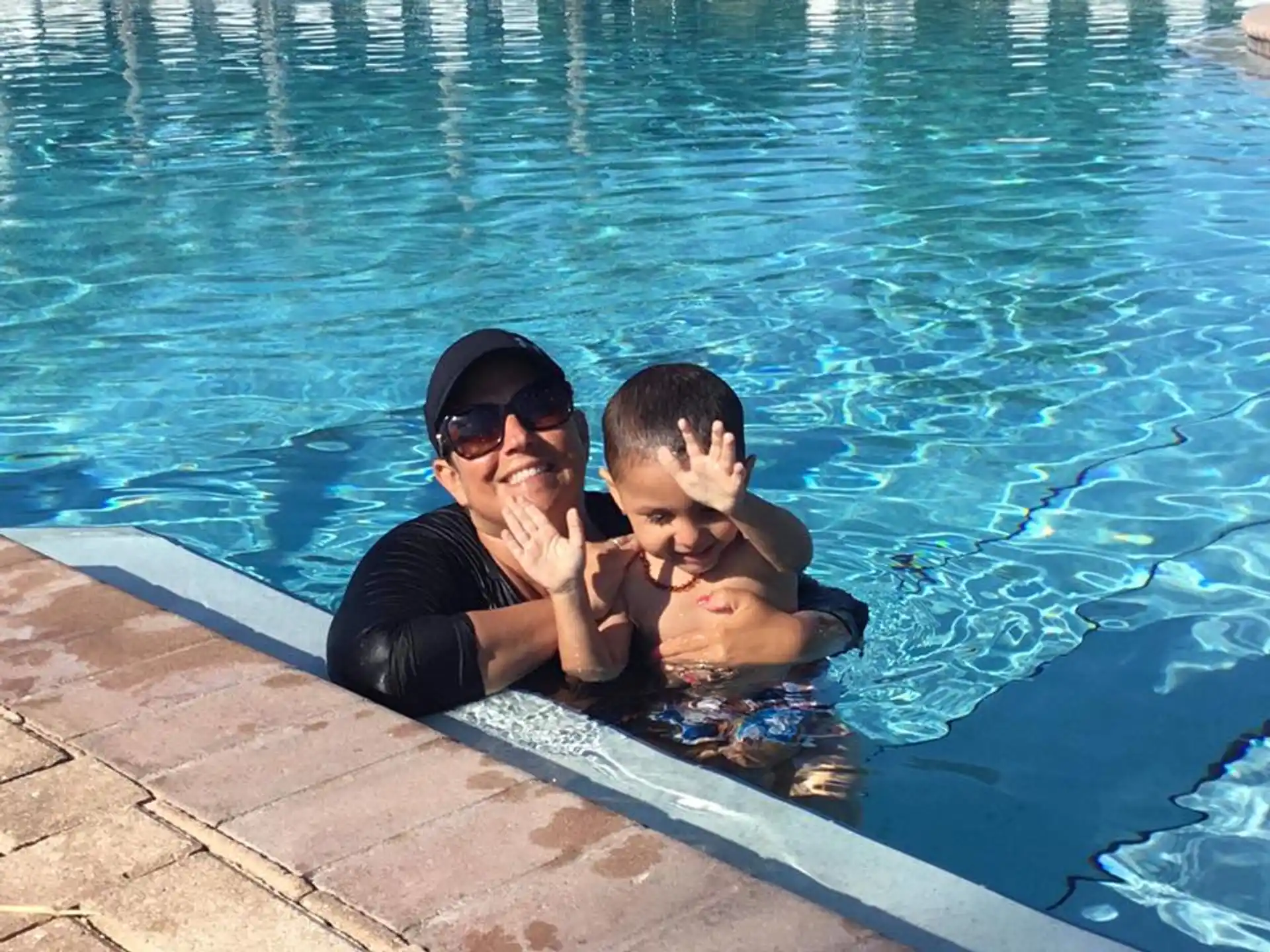 a person and a boy in a pool