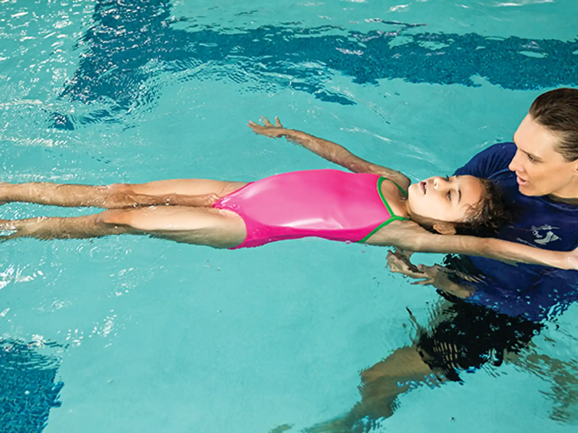 a man and a woman swimming in a pool