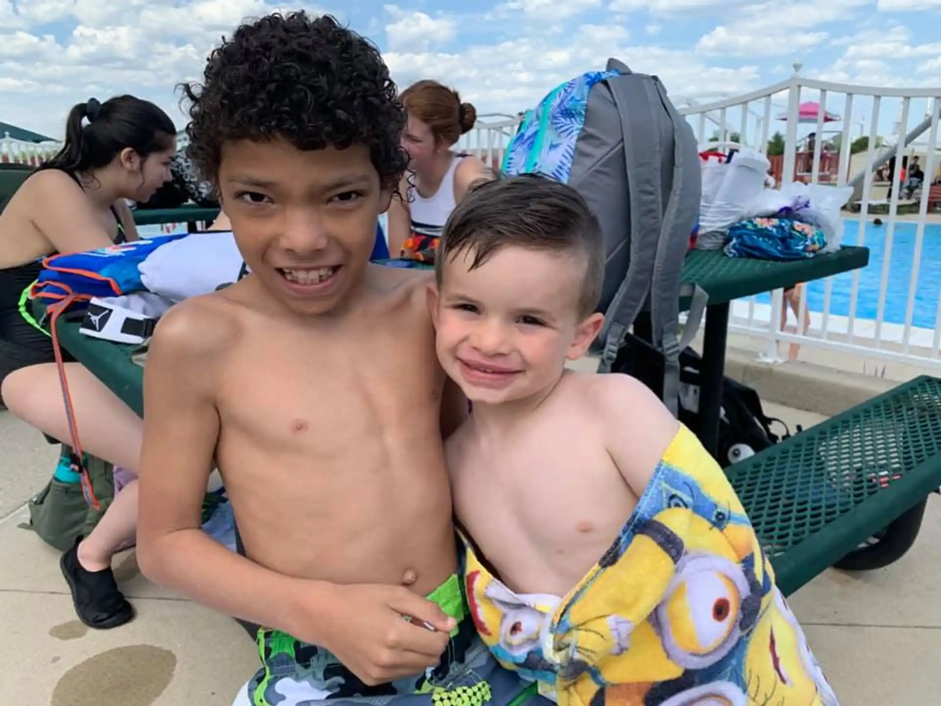 a couple of boys sitting on a beach