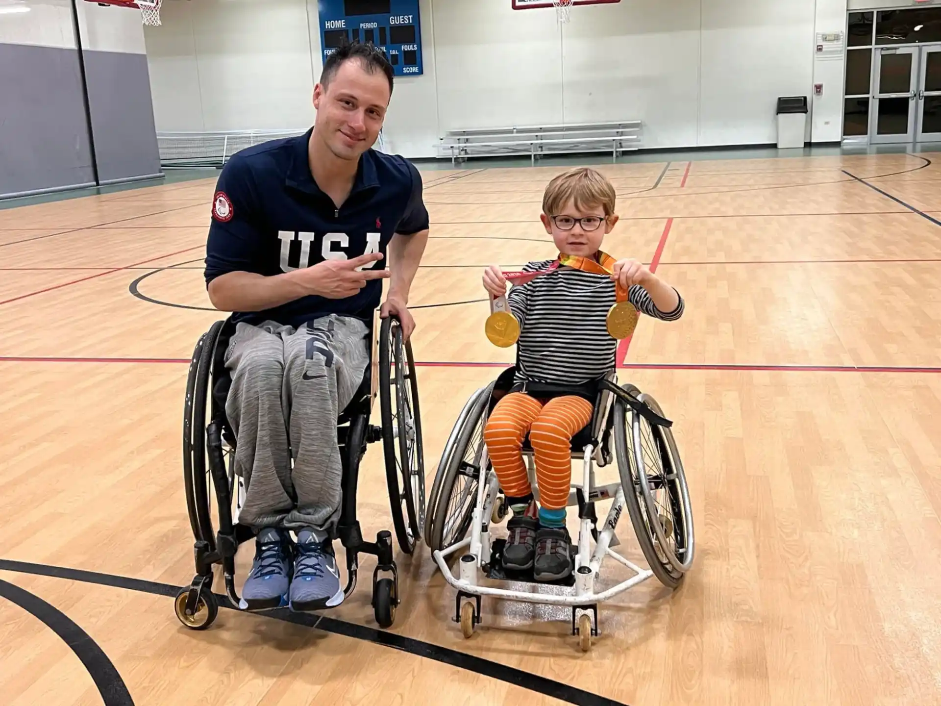 a man and a boy in wheelchairs