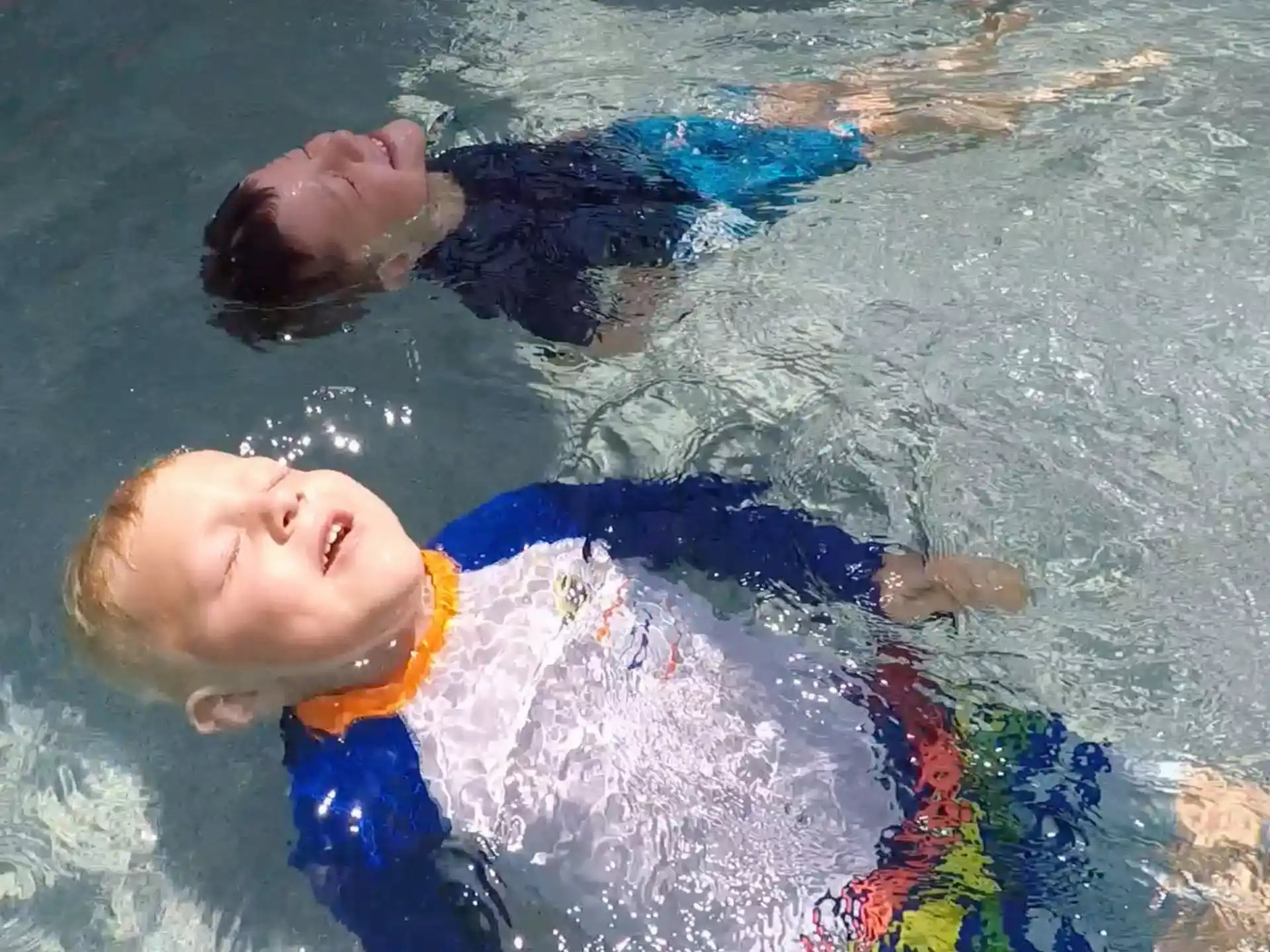 a boy swimming in water