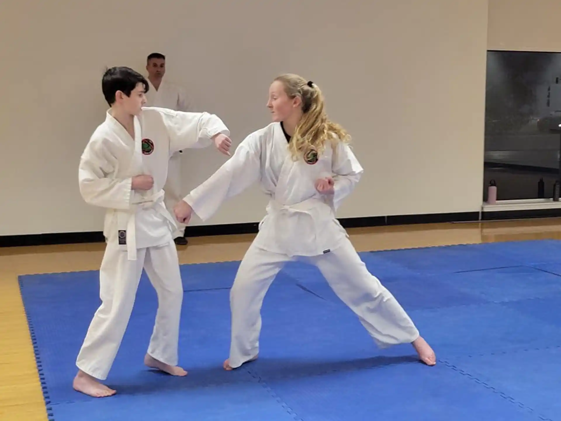 a man and a woman in karate uniforms
