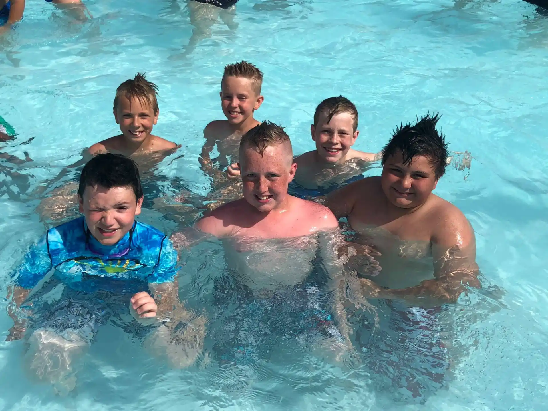 a group of boys in a pool