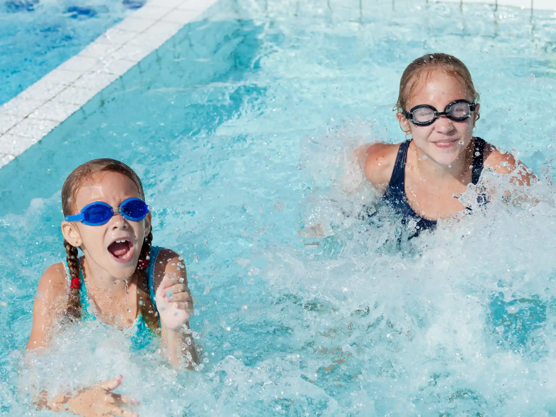 a couple of kids in a pool