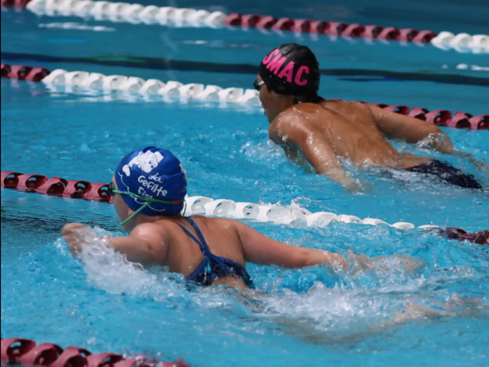 a couple of women swimming in a pool