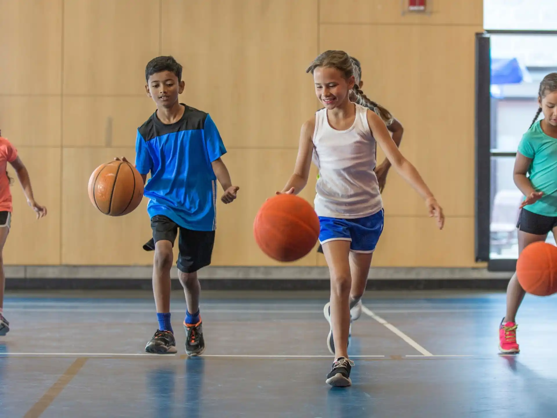 a group of people playing basketball