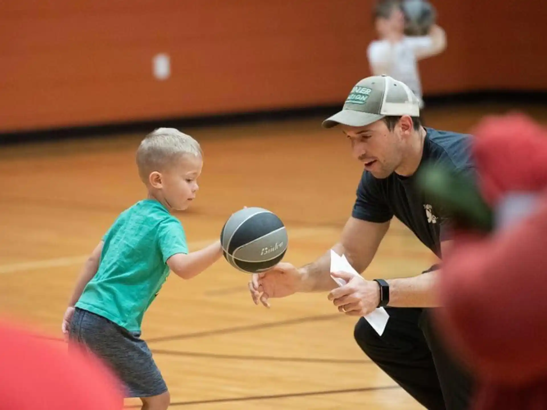 a person and a boy playing volleyball