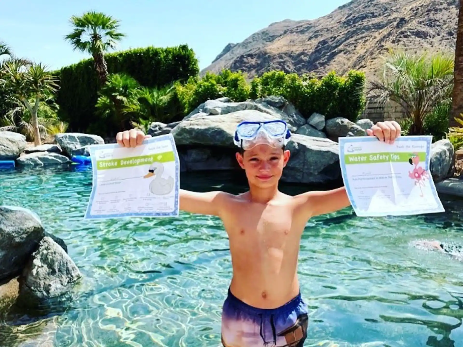 a boy holding a sign in a pool of water