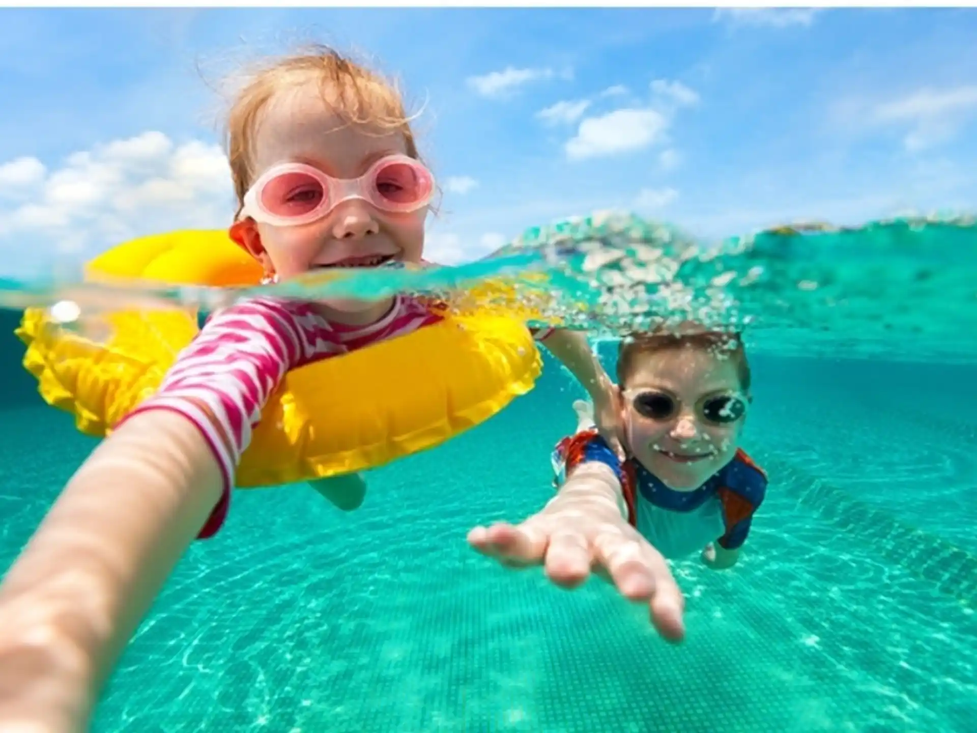 a couple of kids in a pool