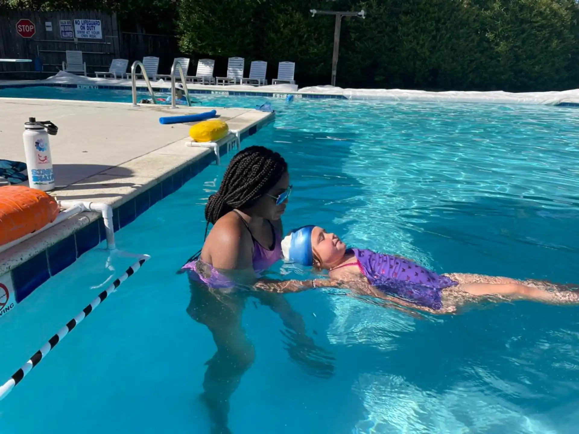 a person and a child in a pool