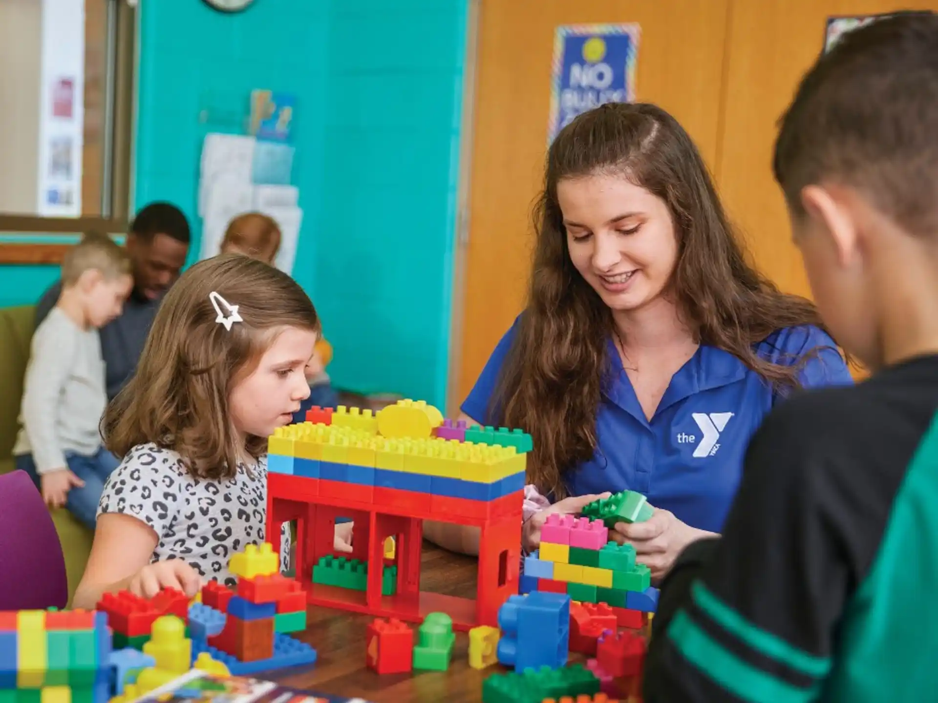 a person and a couple of children playing with a toy