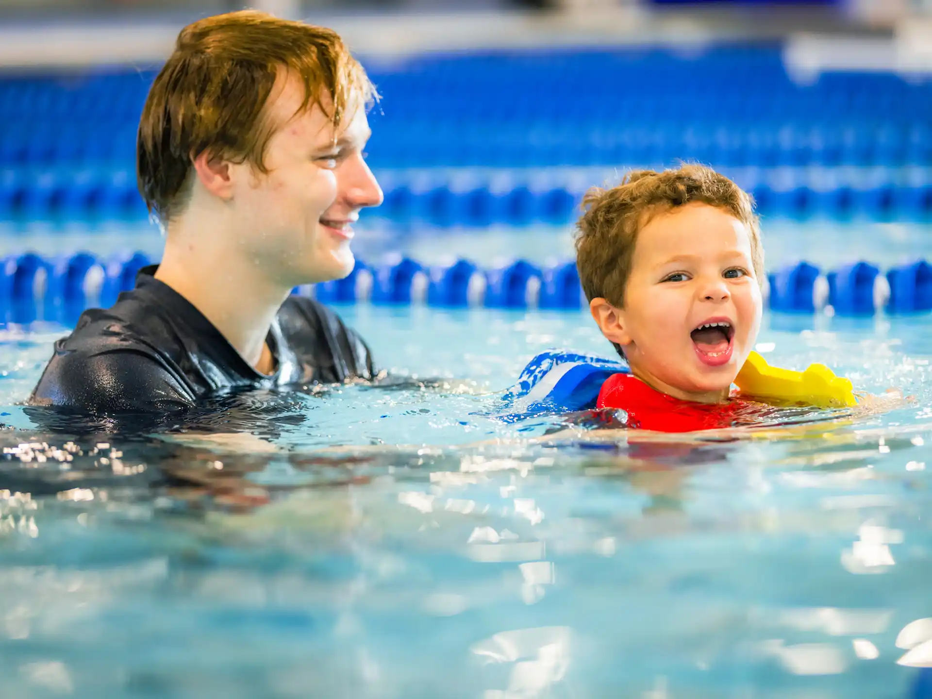 a person and a baby in a pool
