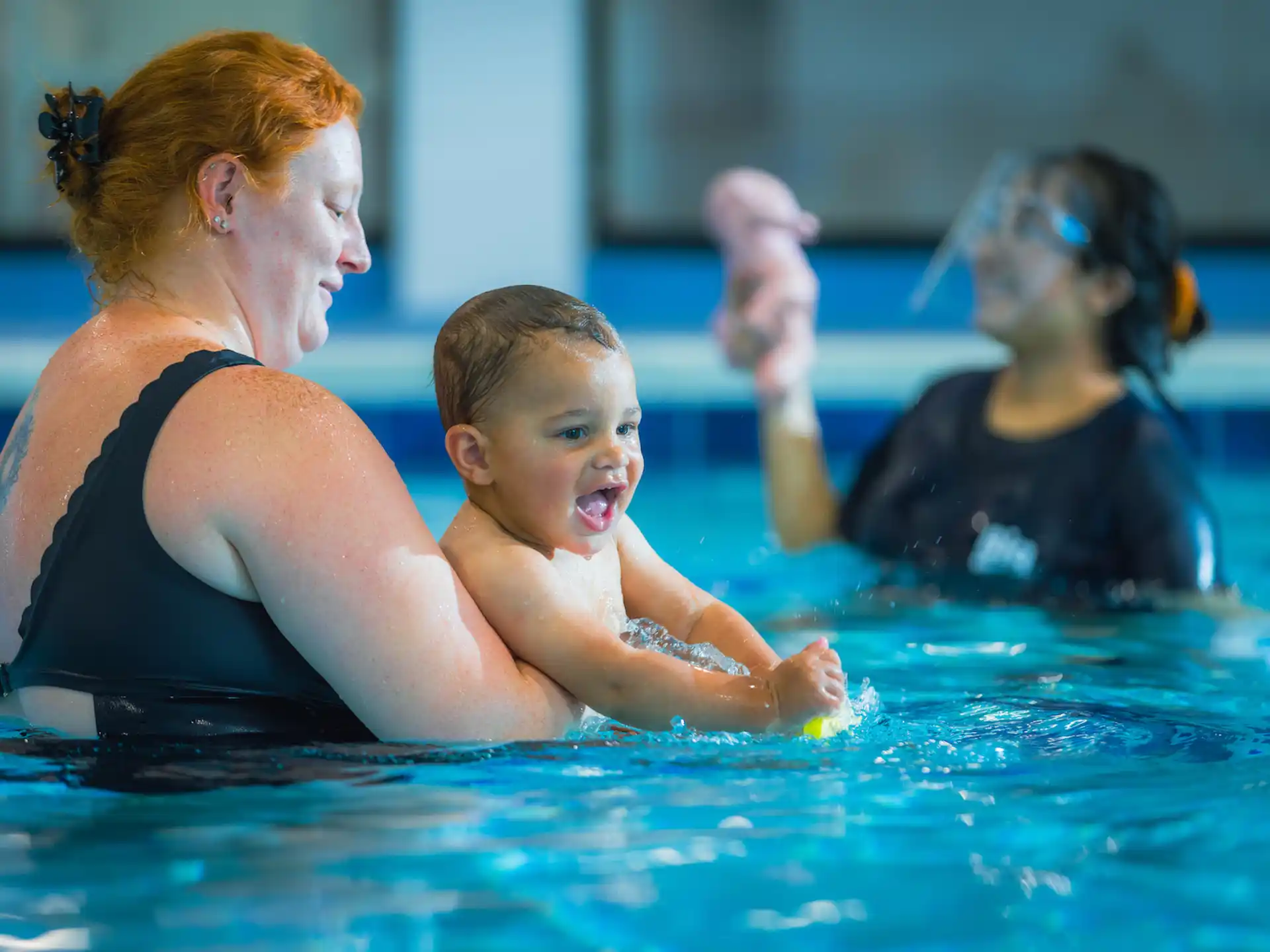 a person and a baby in a pool
