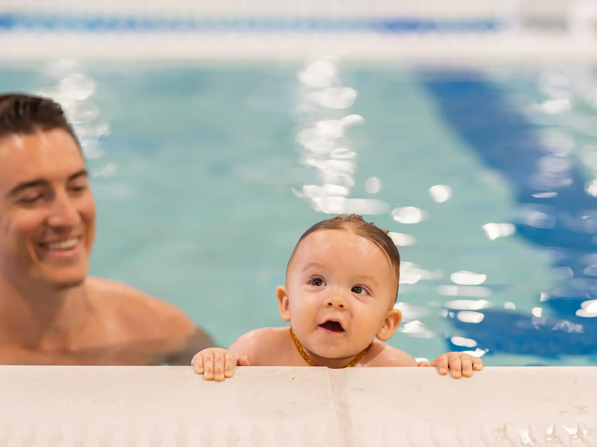 a person and a baby in a pool