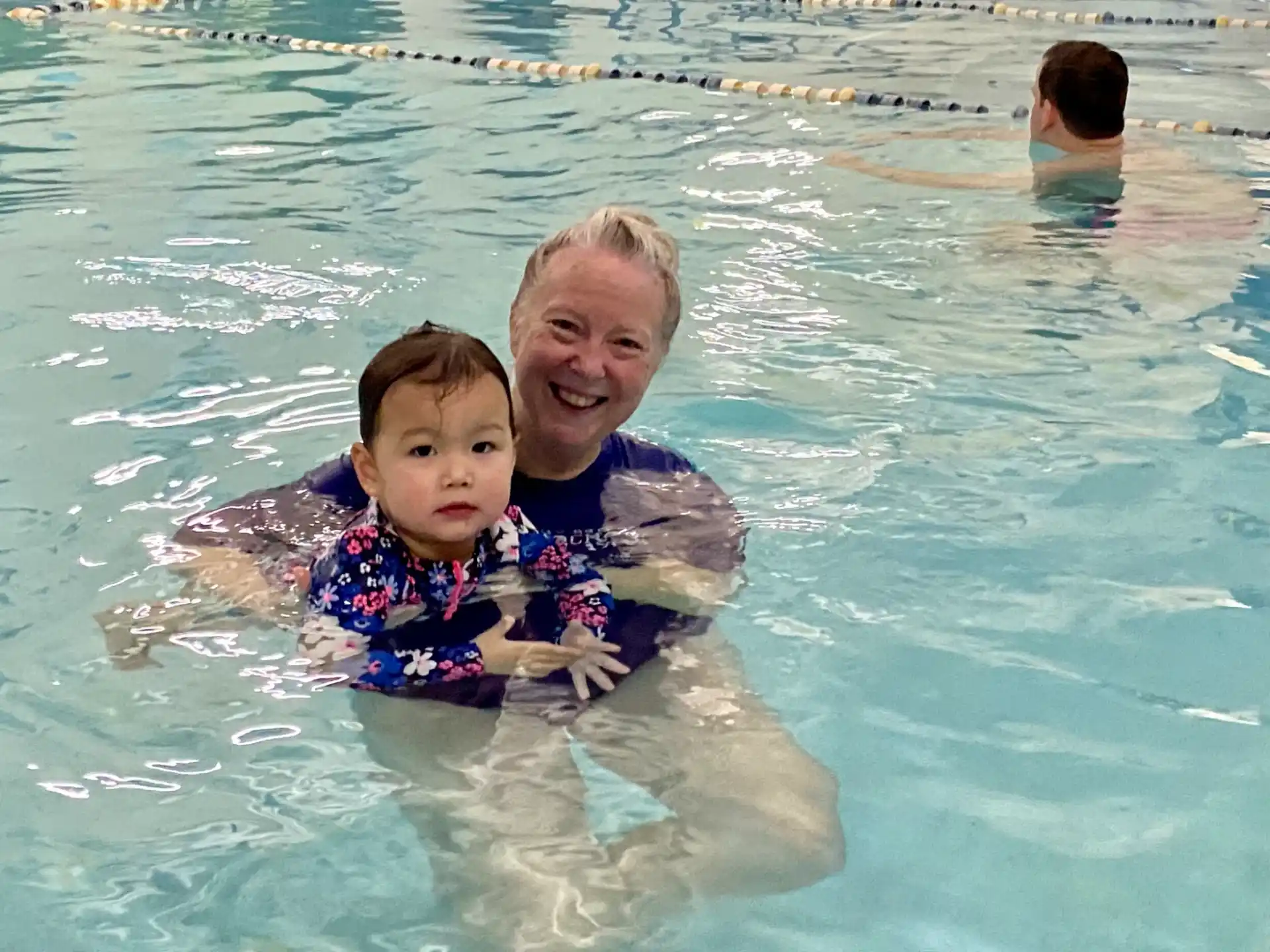 a person and a child in a pool