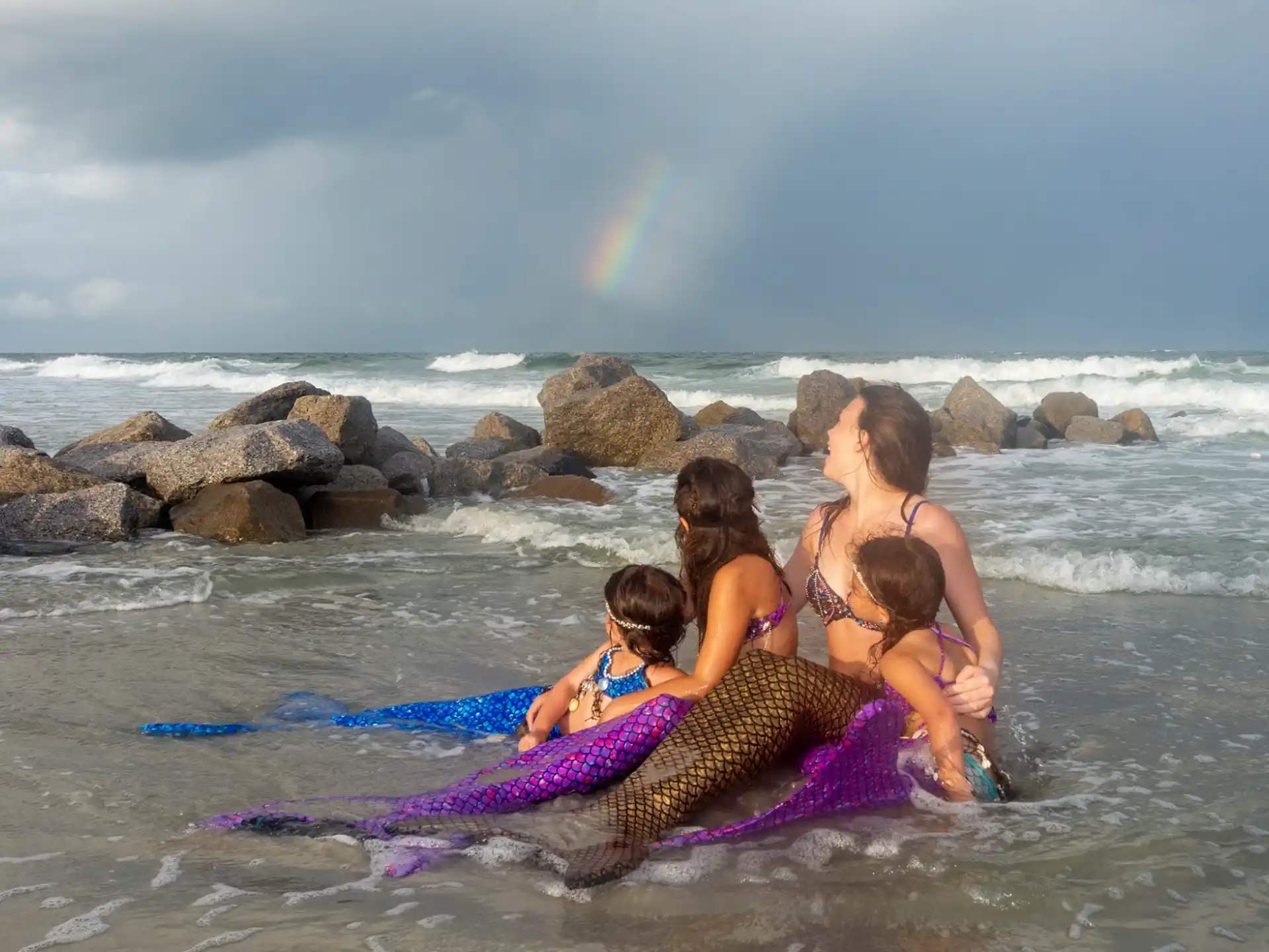 a group of women in garments on a beach