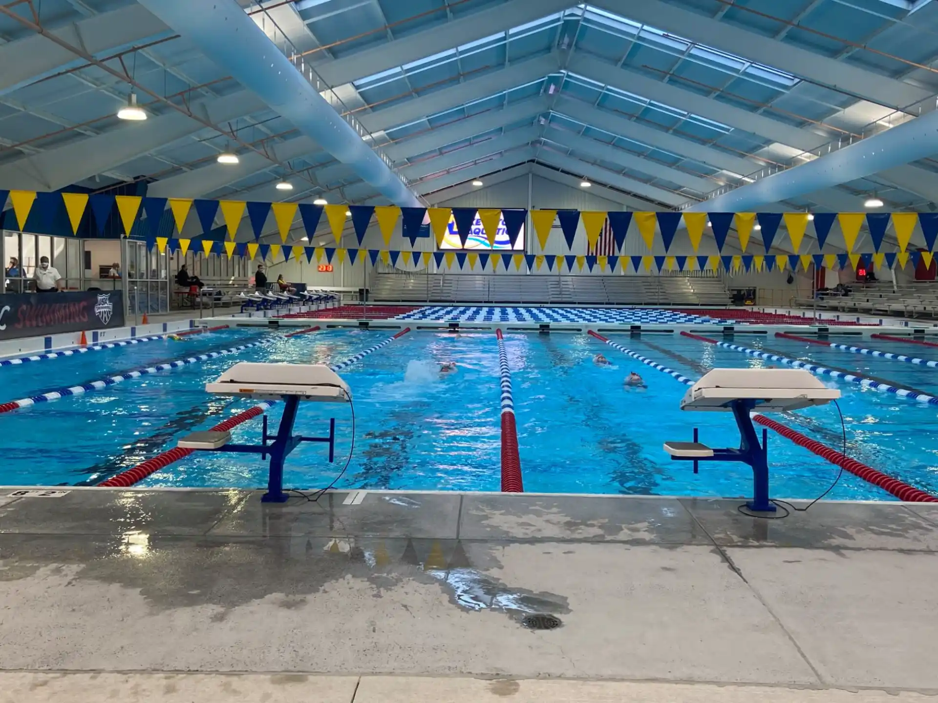 a swimming pool with a large crowd of people in the background