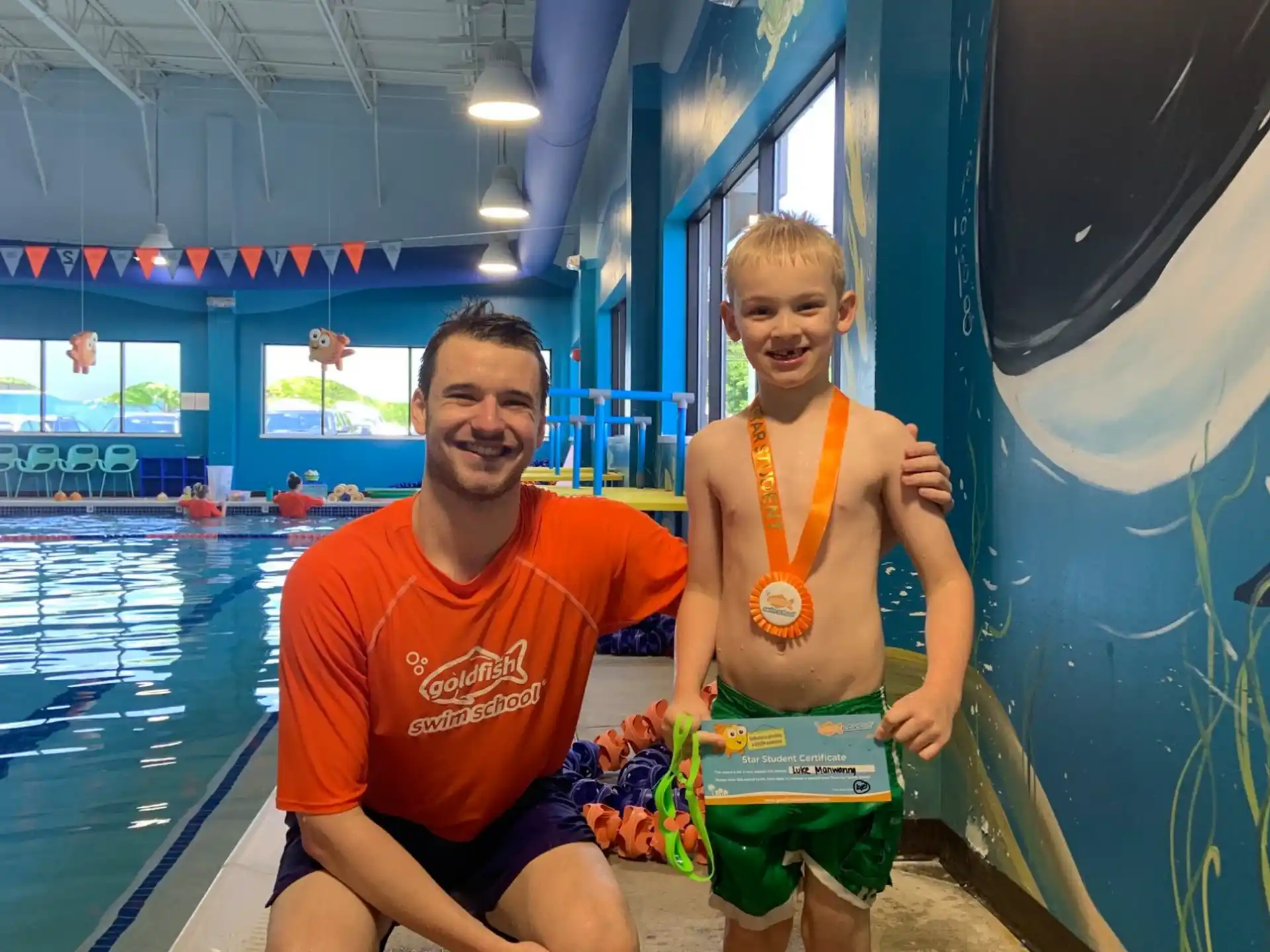 a person and a boy in a pool