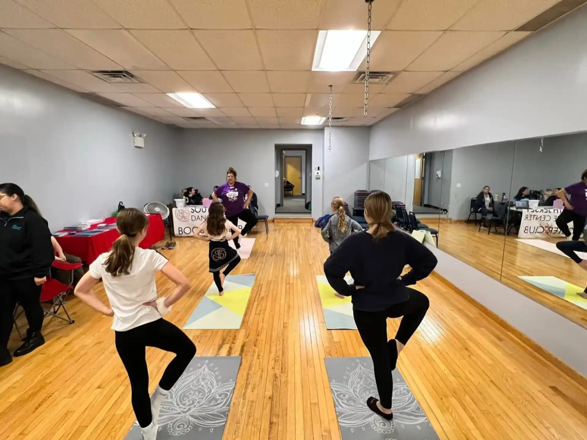 a group of people exercising in a gym