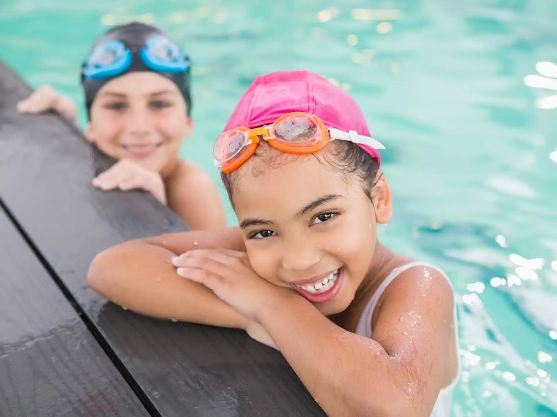 a couple of kids in a pool