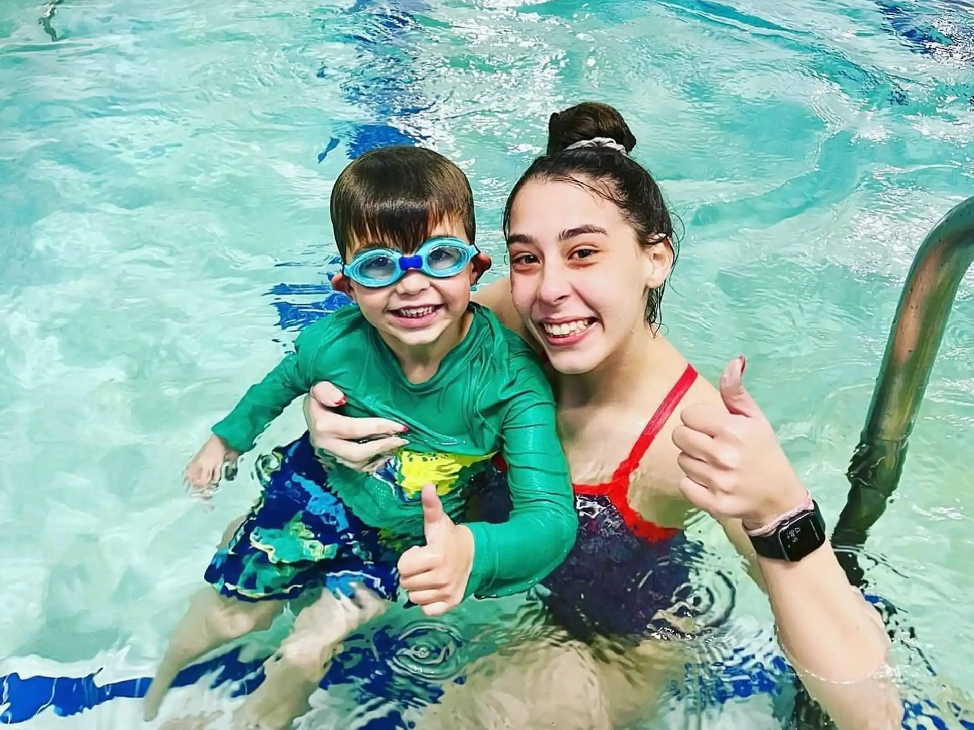 a person and a boy in a pool