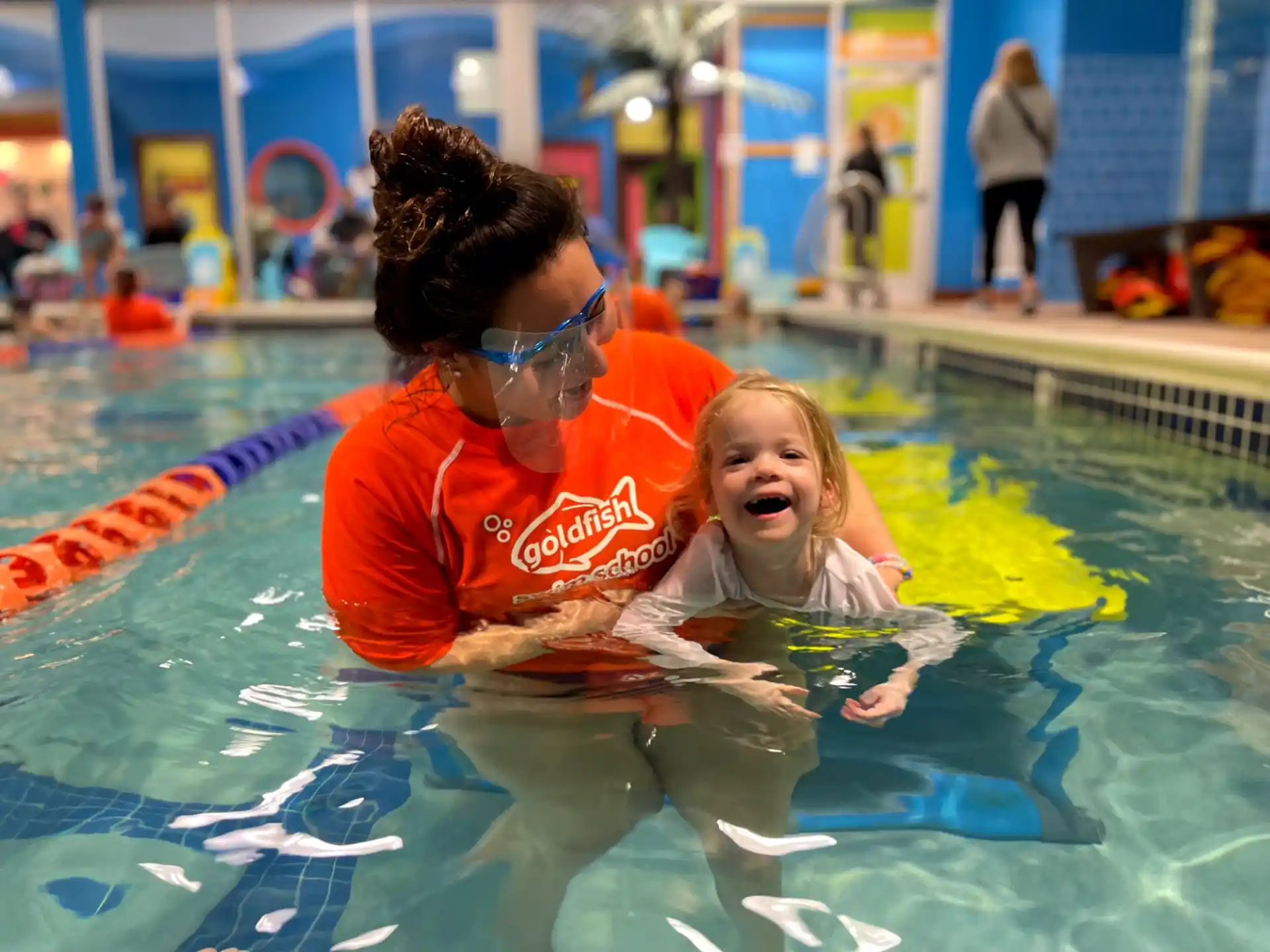 a person and a girl in a pool