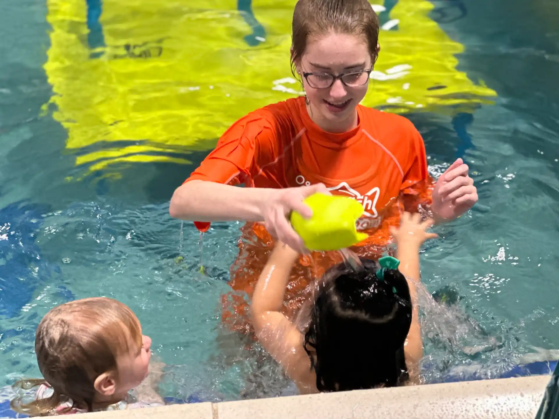 a person and two children in a pool
