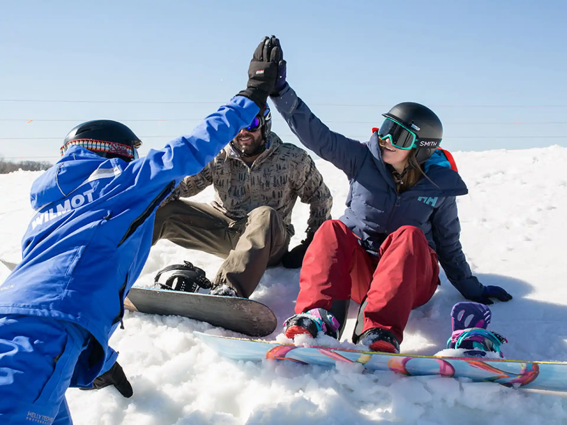 a group of people on snowboards