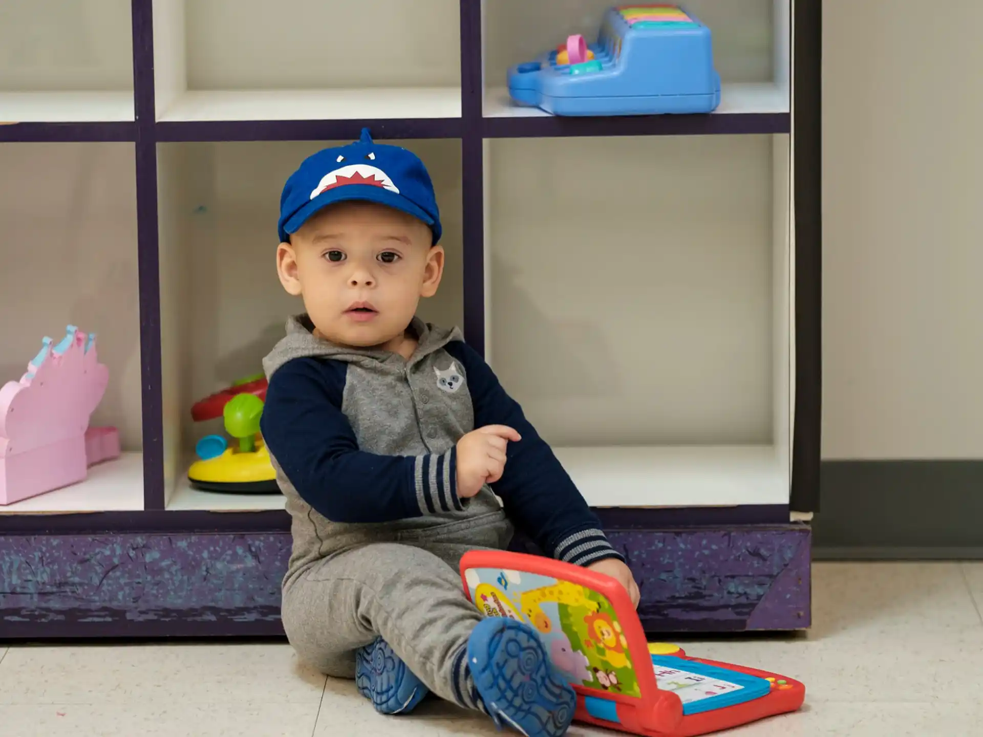 a baby sitting on a toy