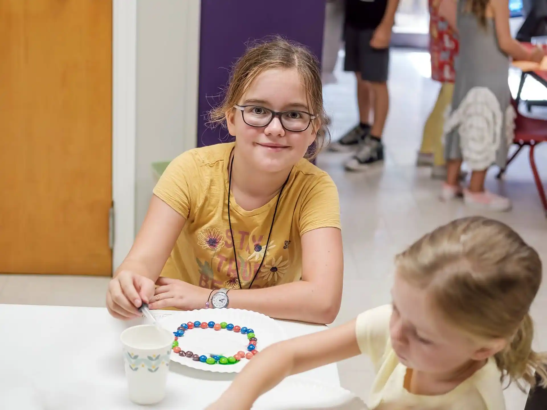 a person and a child eating cake