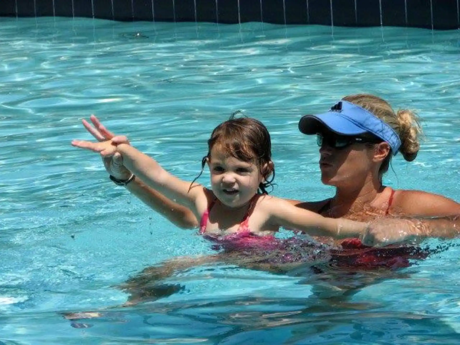 a person and a child in a pool