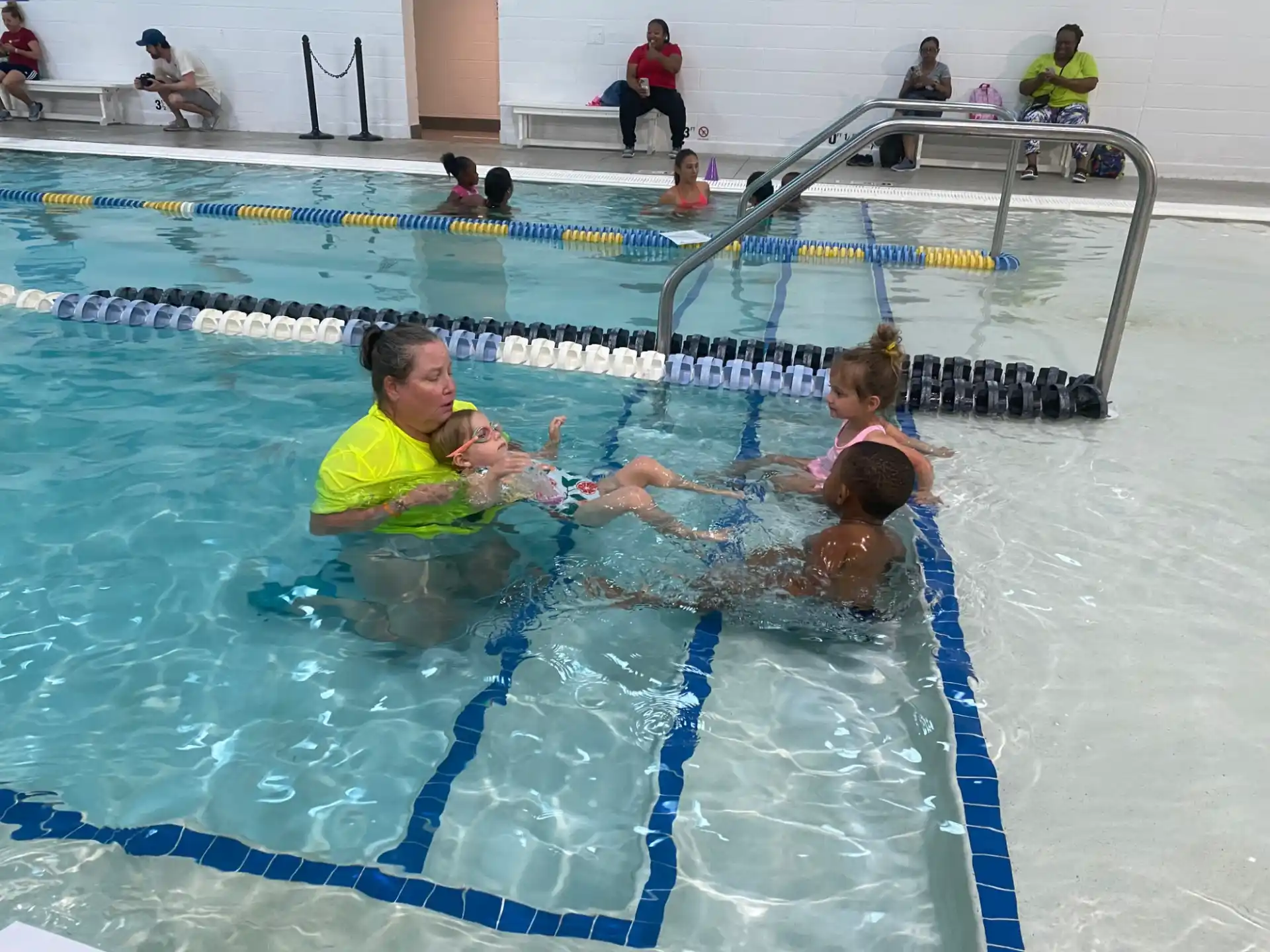 a person and a couple of children in a pool