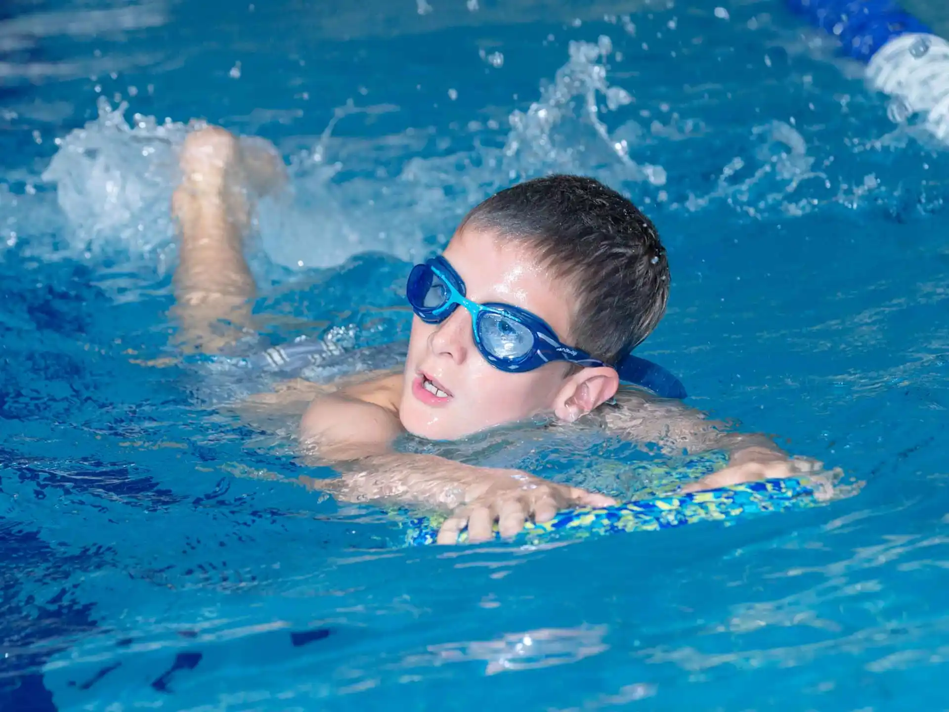 a boy swimming in a pool