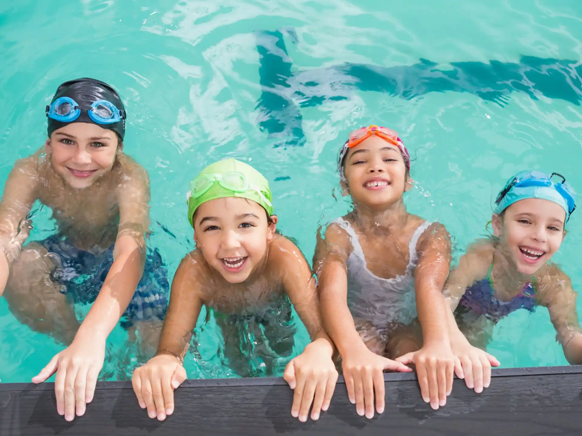a group of girls in swimsuits in a pool