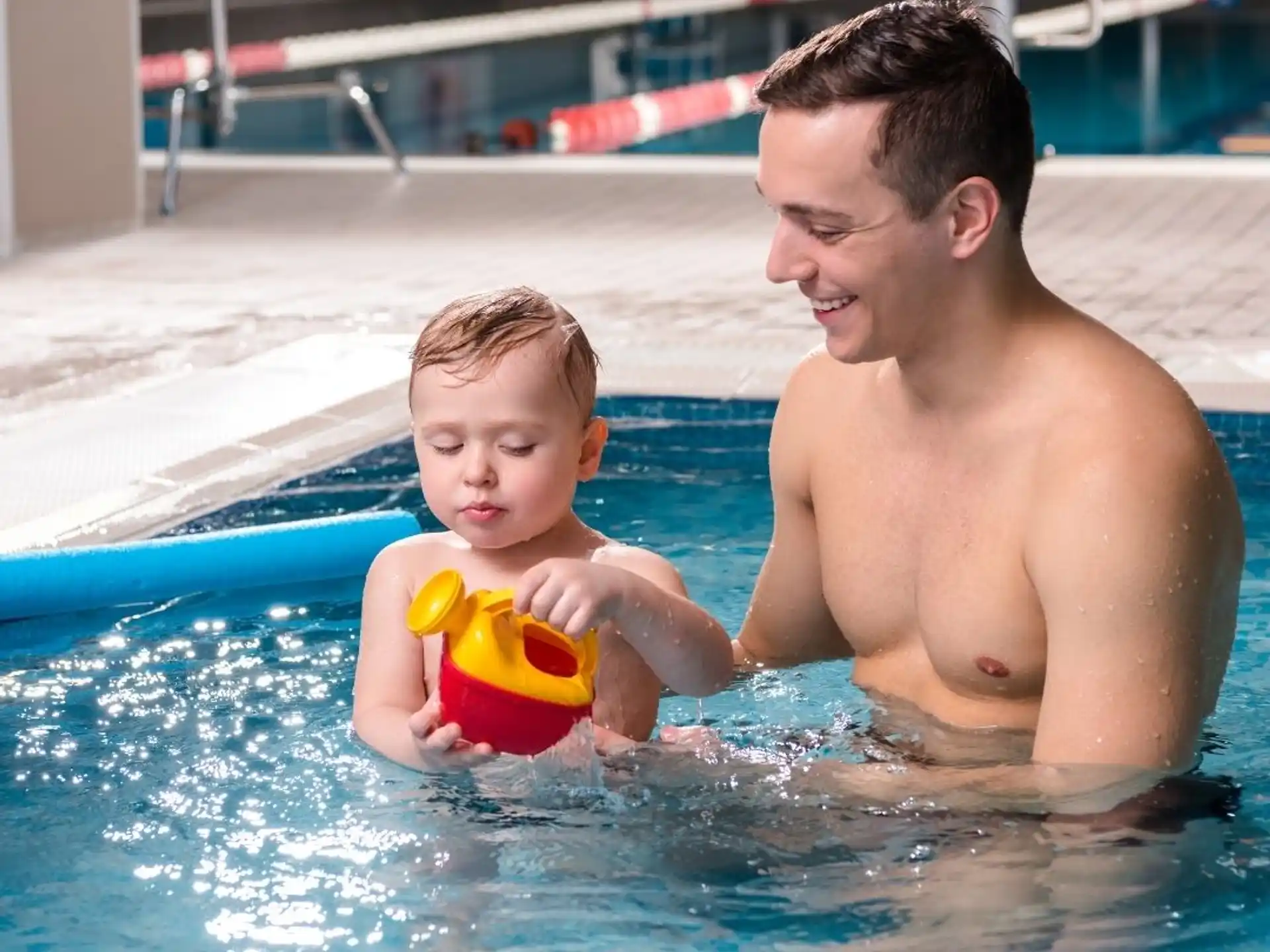 a man and a boy in a pool