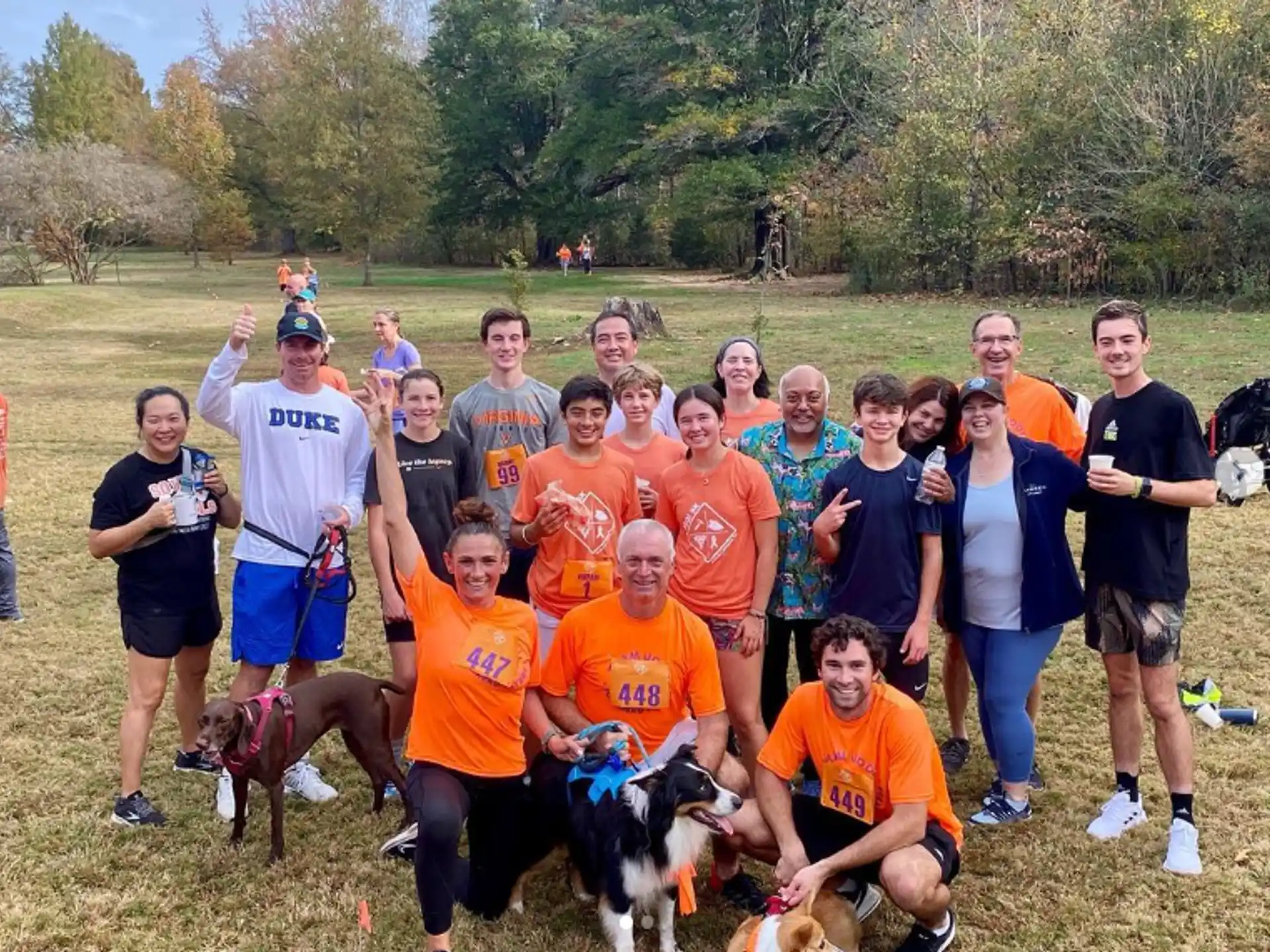 a group of people posing for a photo with dogs