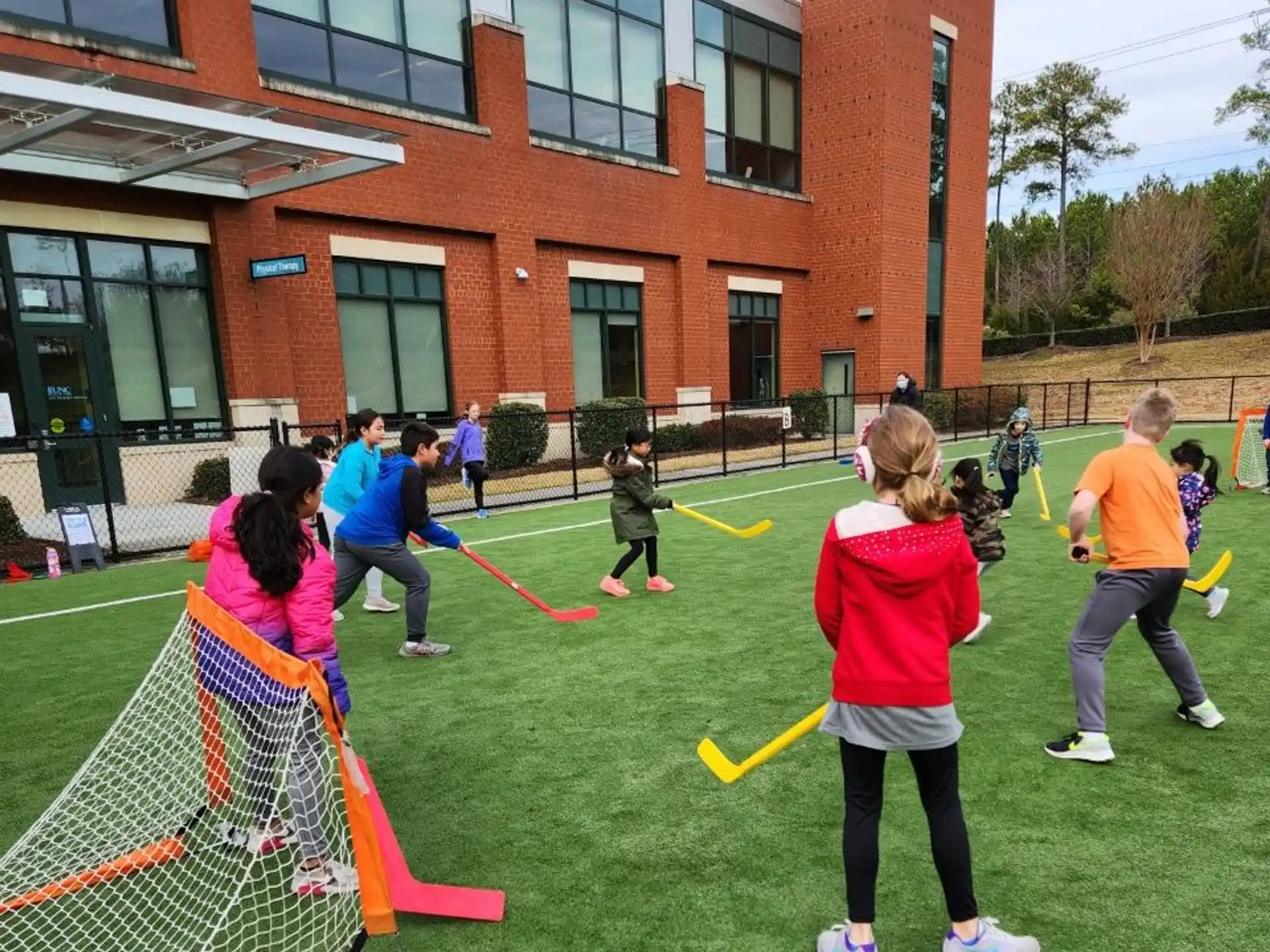 a group of people playing with bows and arrows outside of a building