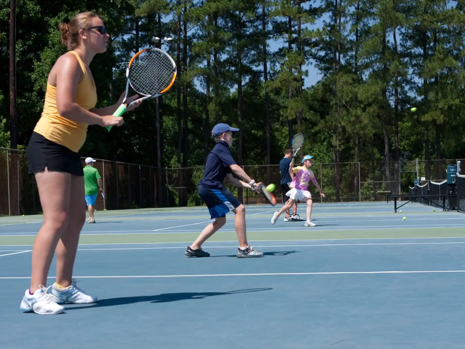 a woman hitting a ball with a tennis racket