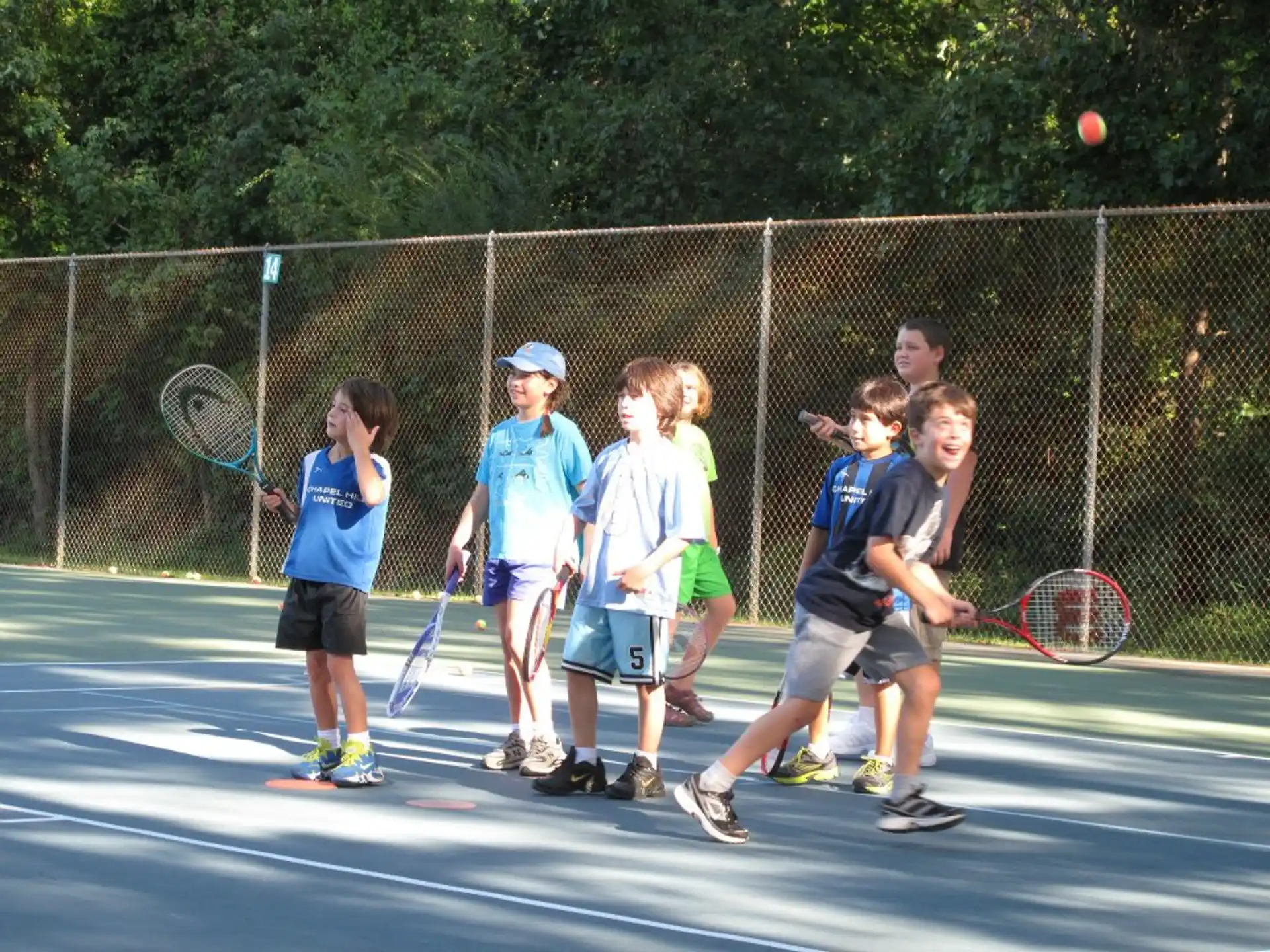 kids playing tennis on a court