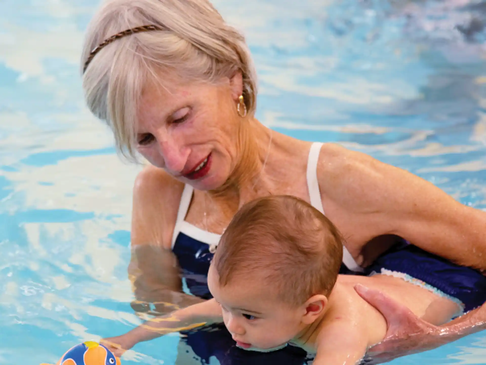 a person and a baby in a pool