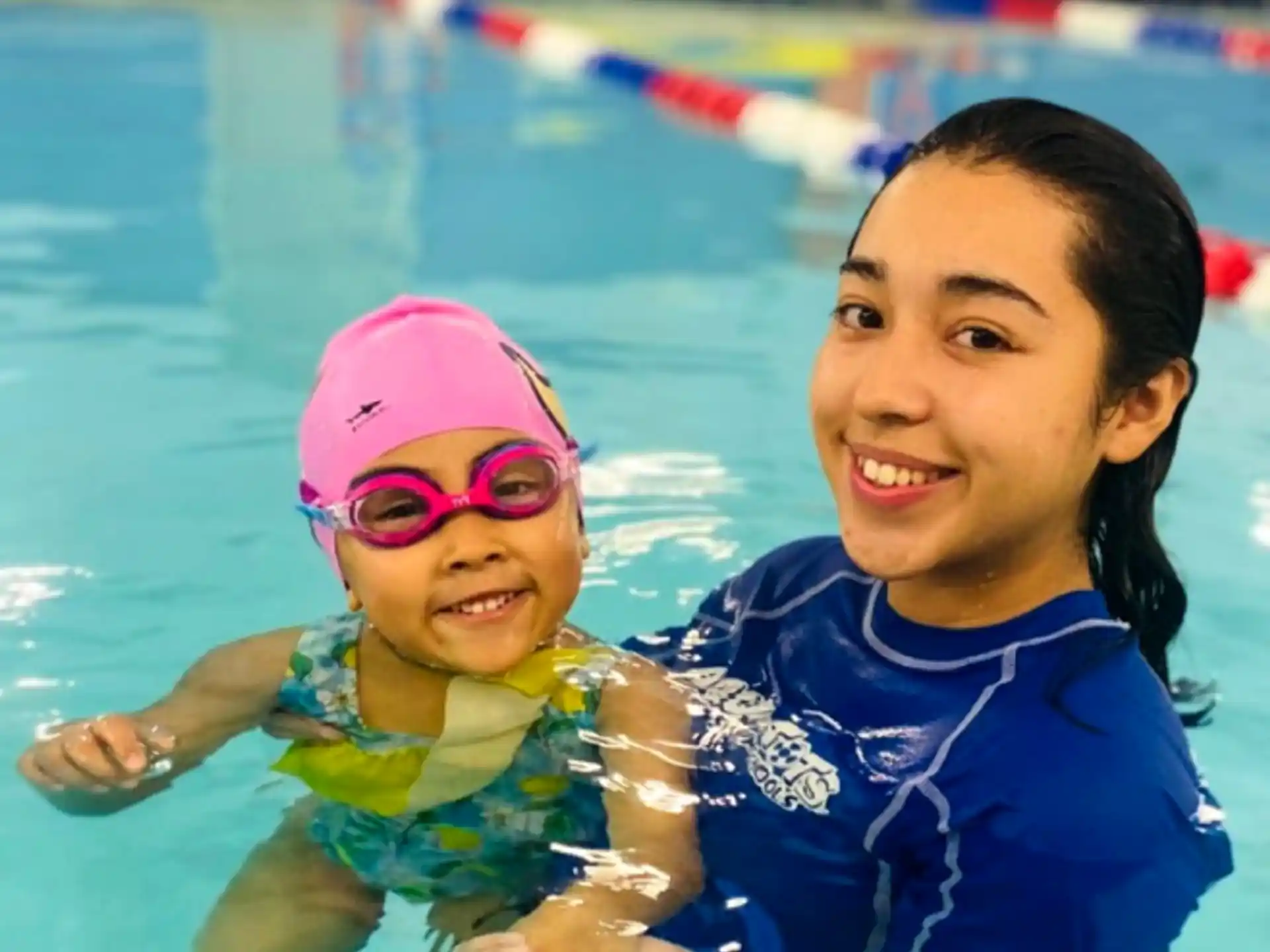 a person and a child in a pool
