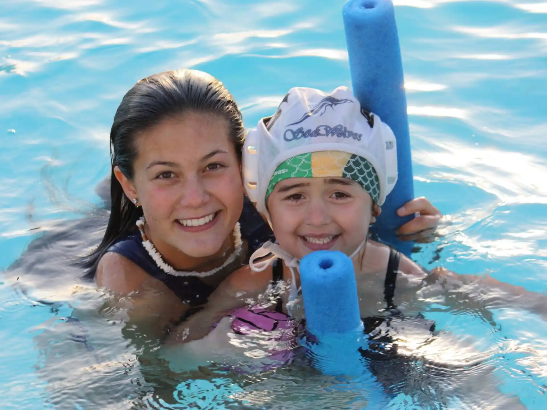 a person and a child in a pool